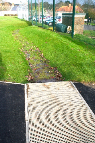 Bridge construction (before swale planting) allows shallow swale depth and grating surface intercepts path runoff.