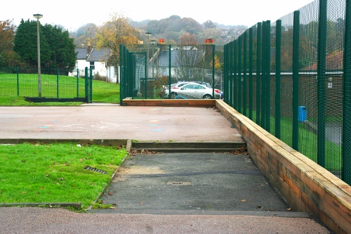 Timber seating wall converts an existing hard play area into a water large storage facility whilst providing added amenity for children.