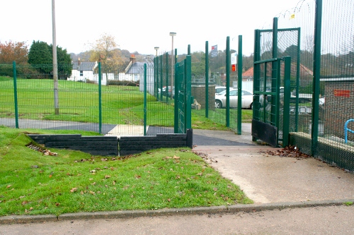 The recycled plastic slot weir is located adjacent to a gate, modified to retain stored water, and beyond the fence, the start of the timber sleeper storage wall (prior to planting).